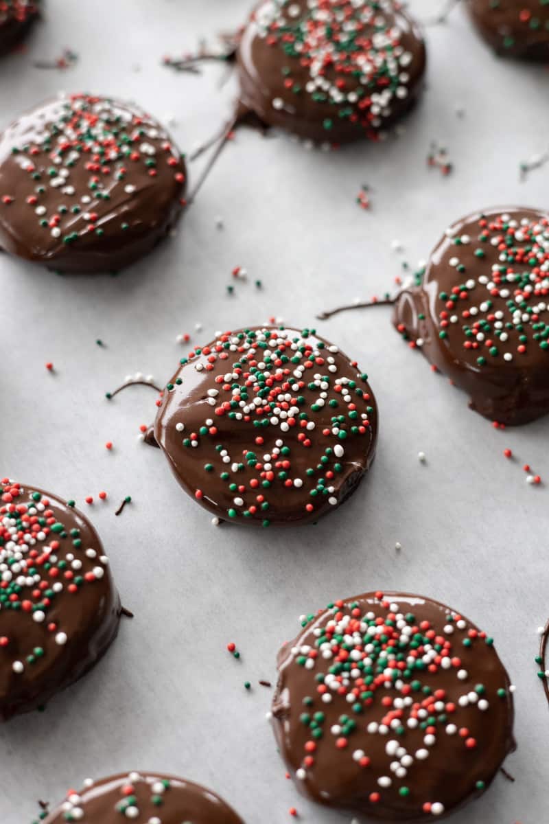 Sprinkles on top of the chocolate coated cookies. 