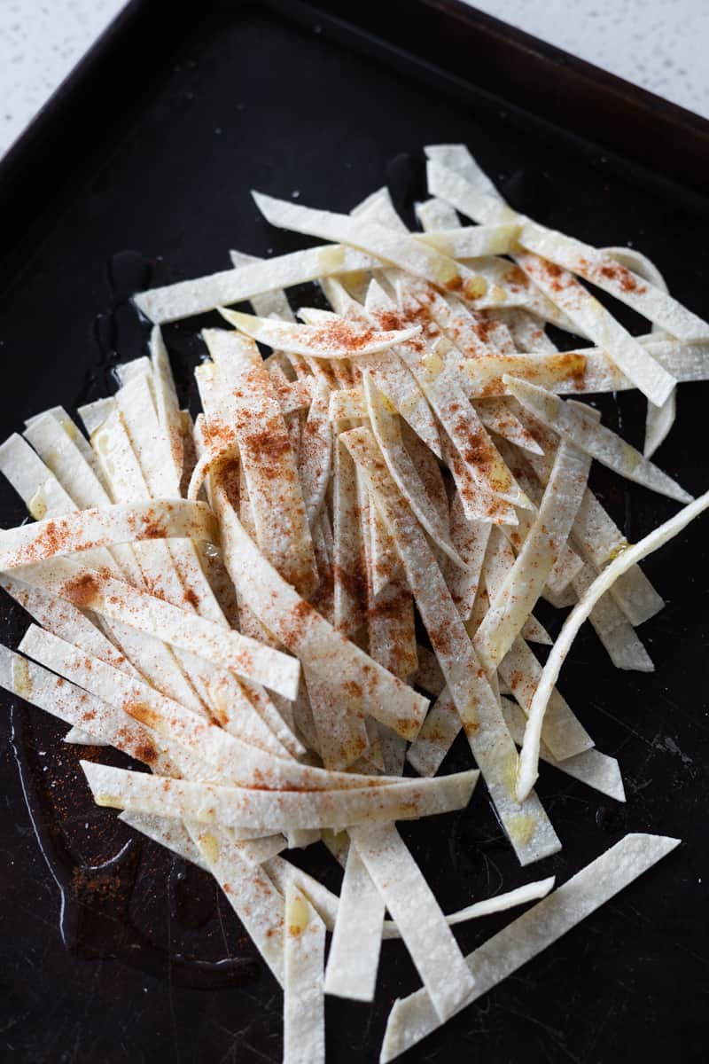 Tortilla strips drizzled with olive oil, salt and paprika. 