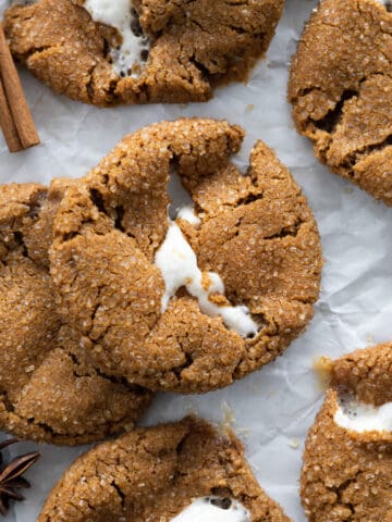 Molasses marshmallow stuffed cookies in a pile on a tray.