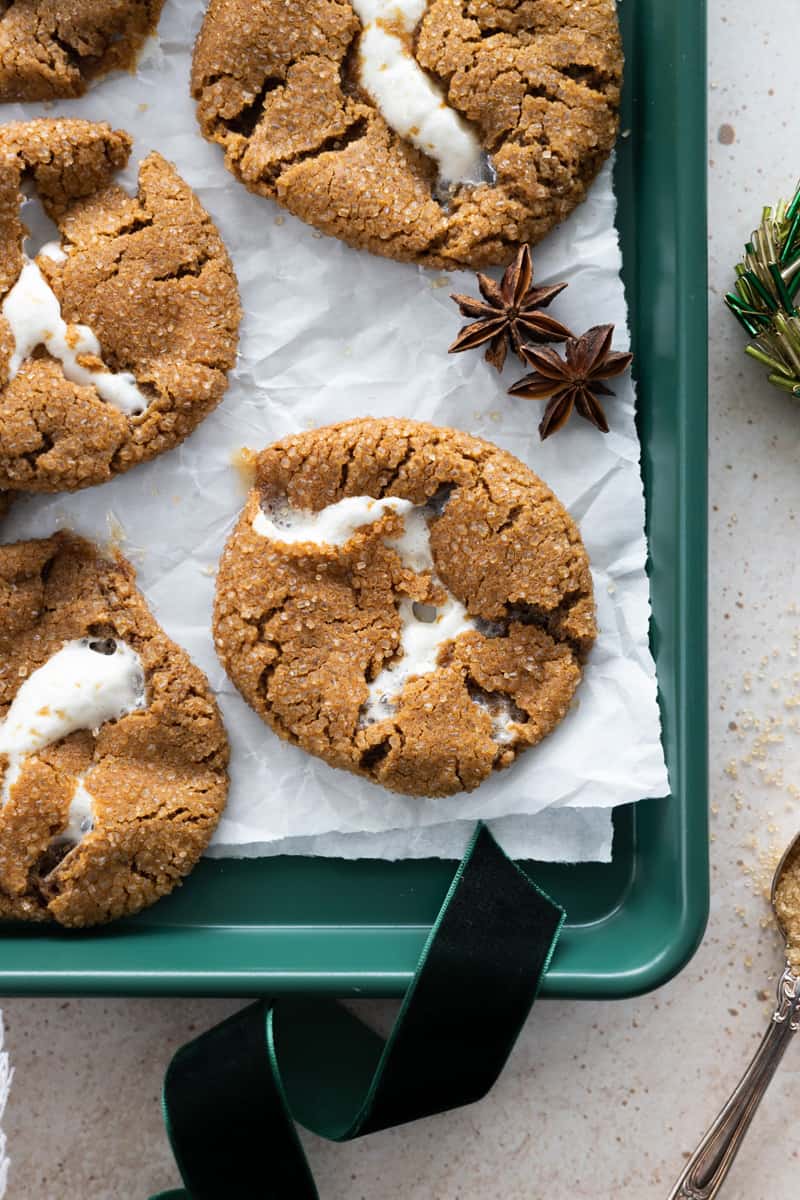 Molasses Marshmallow Stuffed Cookies on a green tray with white parchment paper. 