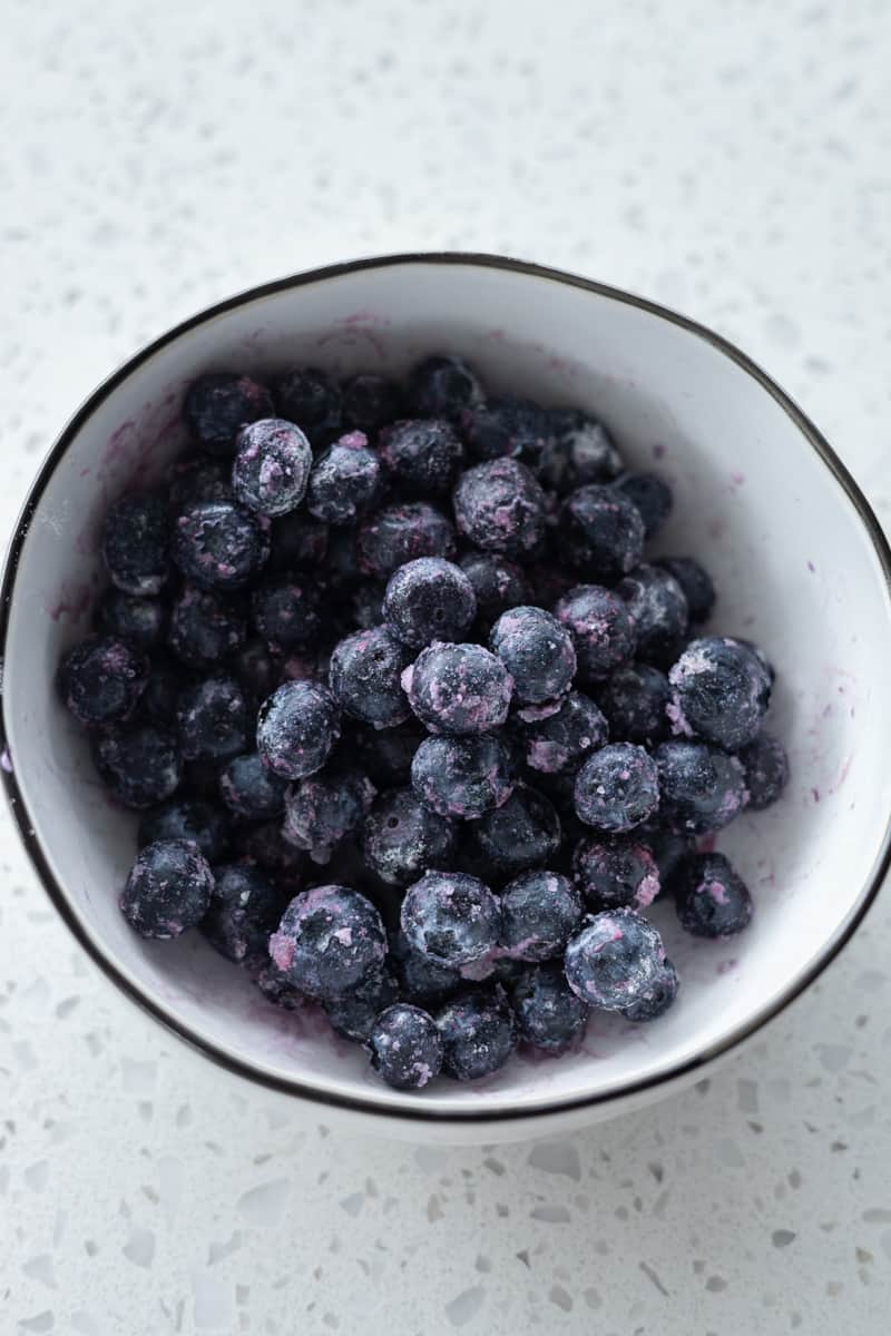 Blueberries tossed in flour in a small bowl. 