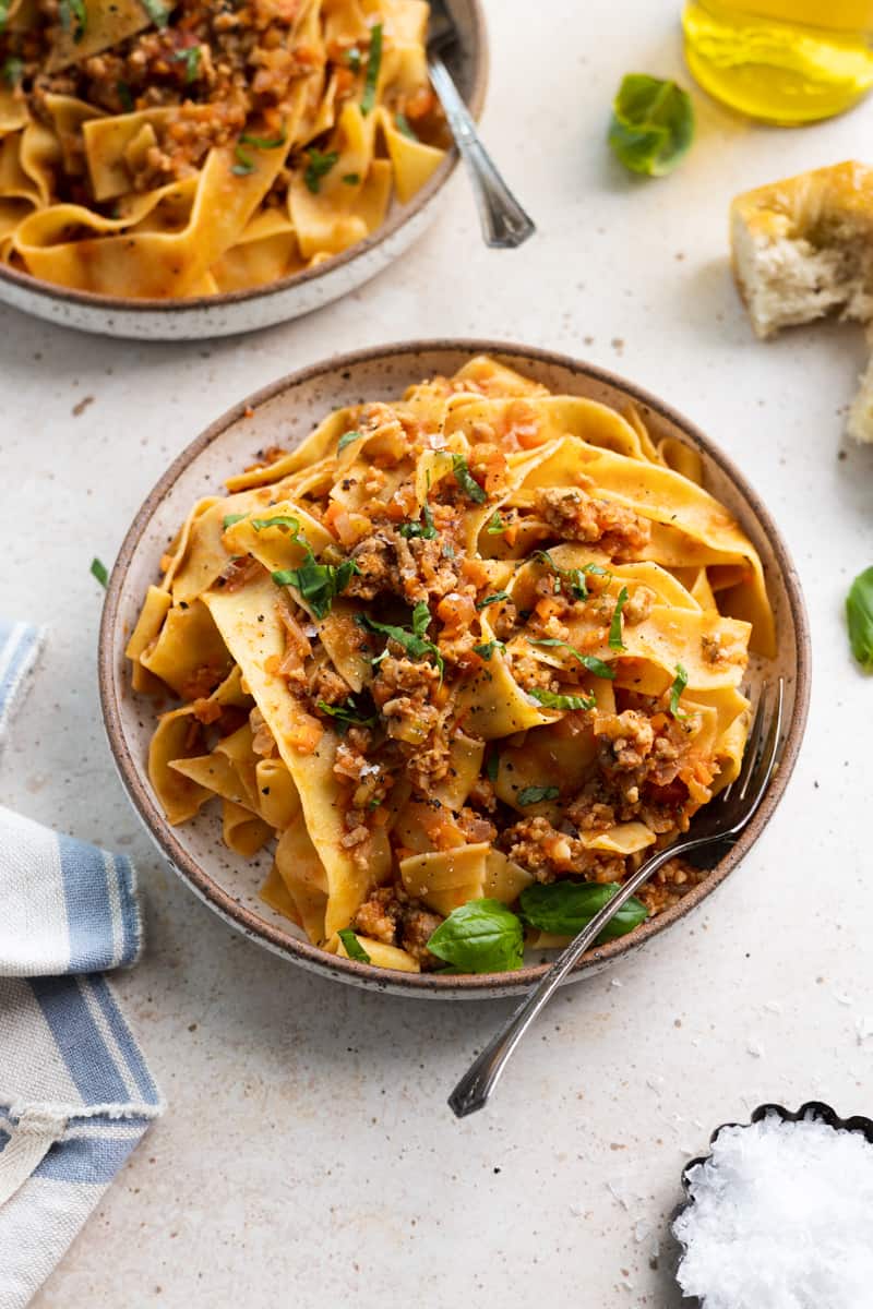 Chicken bolognese in a bowl with a fork.