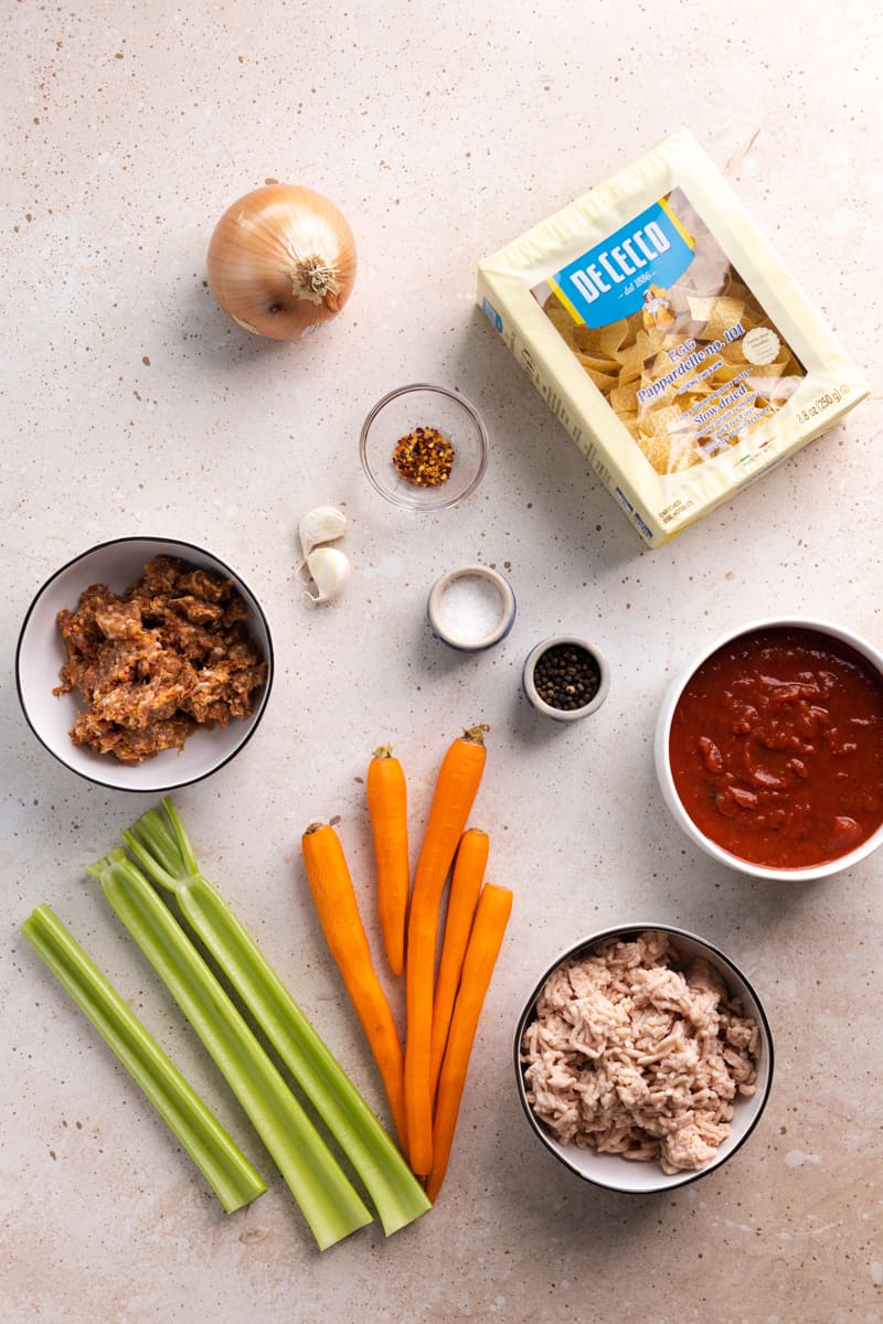 Ingredients for chicken bolognese in small bowls. 