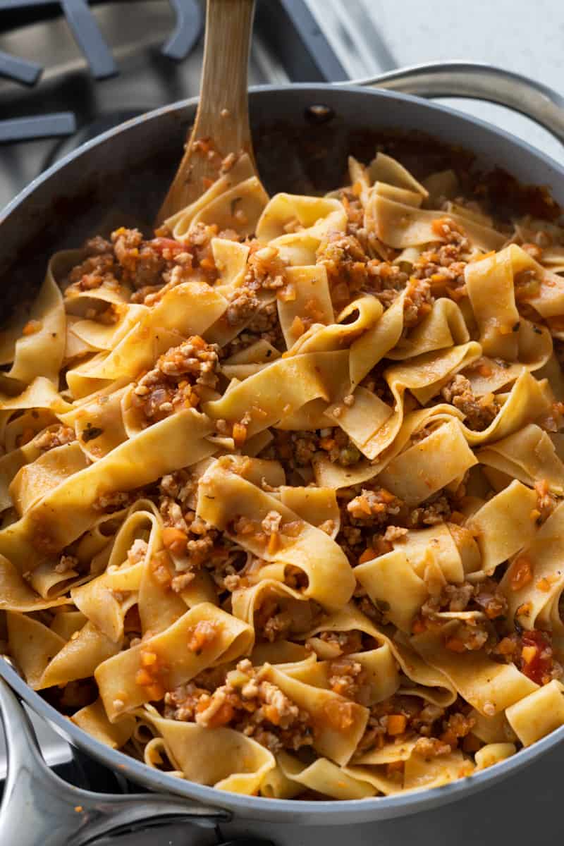 Noodles tossed in the bolognese sauce. 