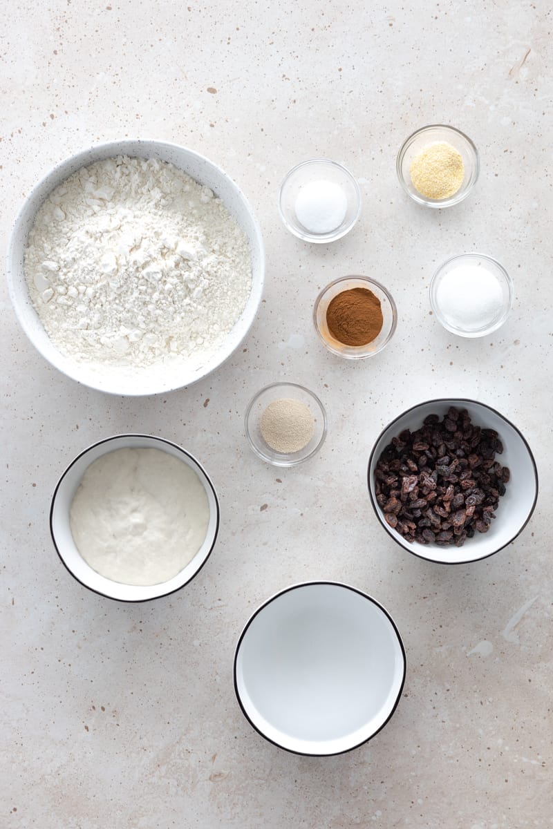 Ingredients for cinnamon raisin sourdough discard bagels in small bowls. 