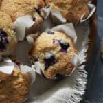 Sourdough Discard Blueberry Muffins on a wooden board.