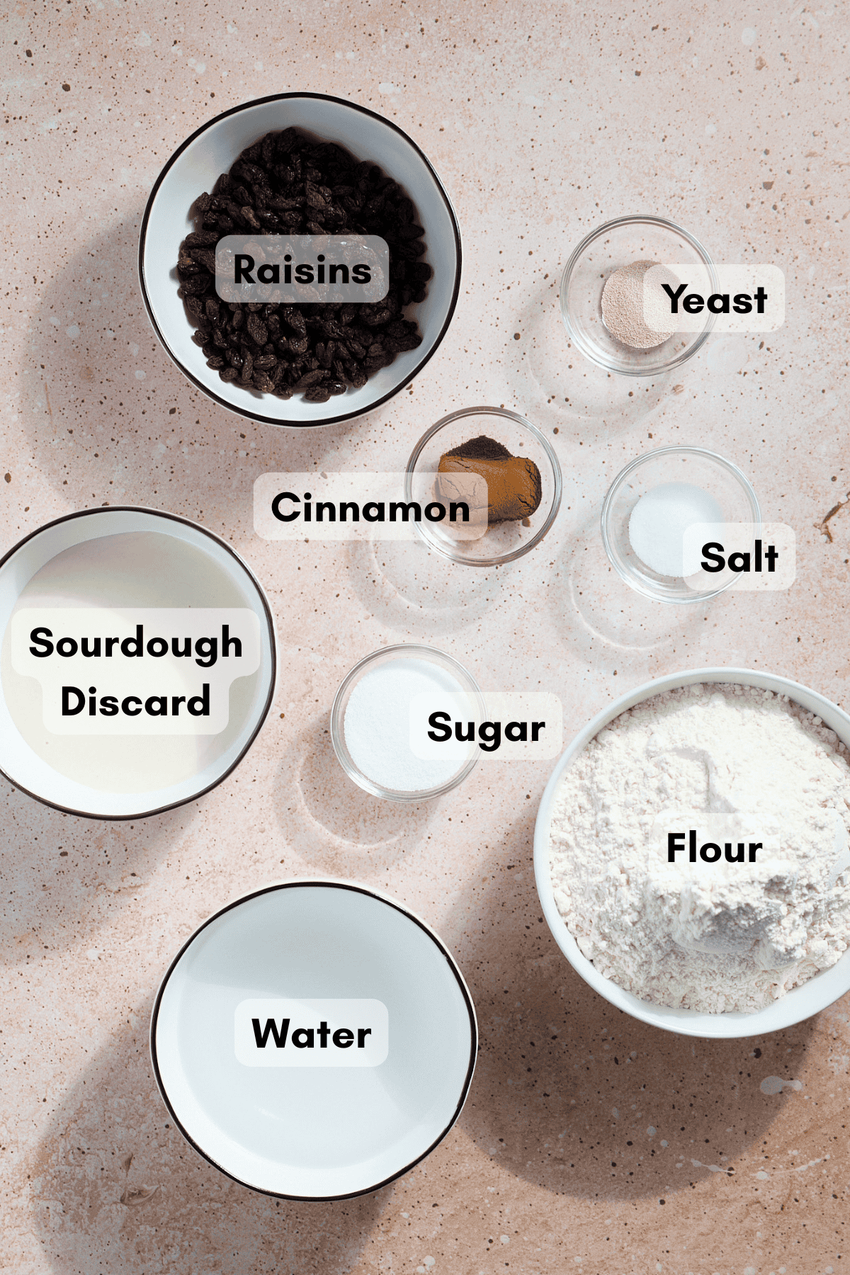 Ingredients for Sourdough Discard Cinnamon Raisin Bagels in small bowls.