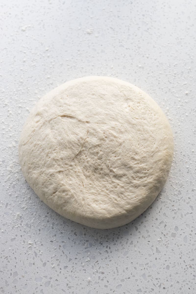 Sourdough discard pizza dough on a work surface.
