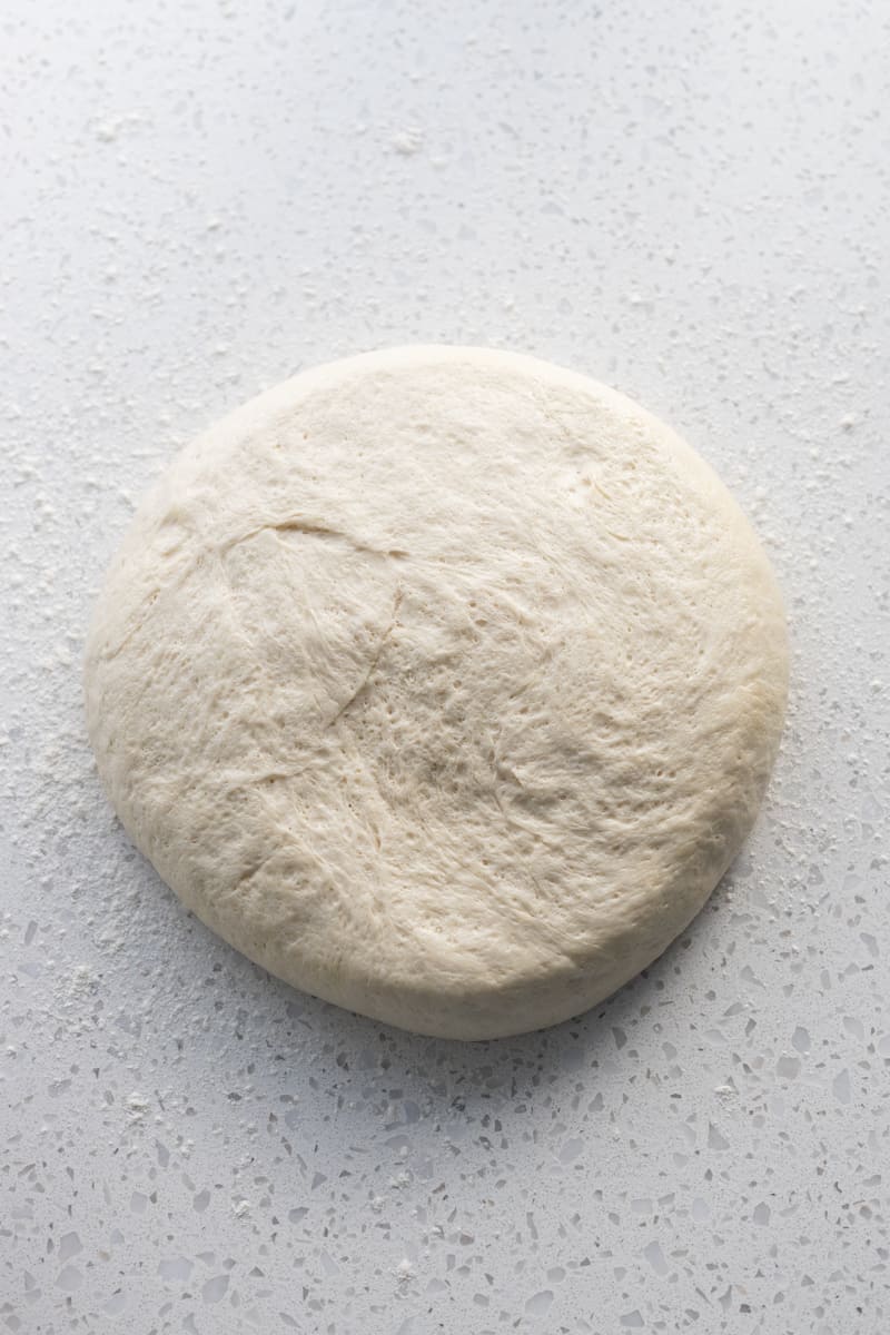 Sourdough discard pizza dough on a work surface.