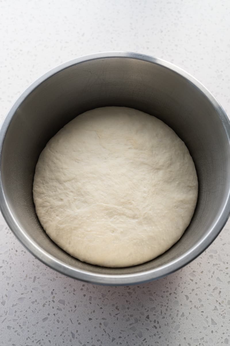 Sourdough discard pizza dough after rising in a large bowl.