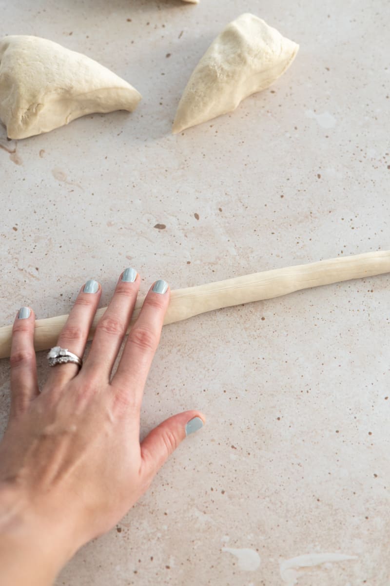 Hand rolling the dough into a rope. 