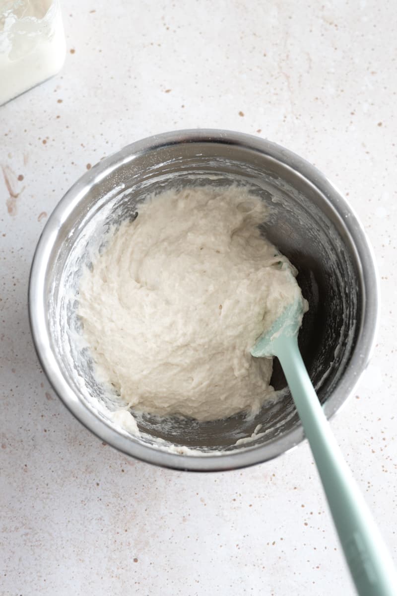 Starter mixed together with flour and water in a metal bowl. 