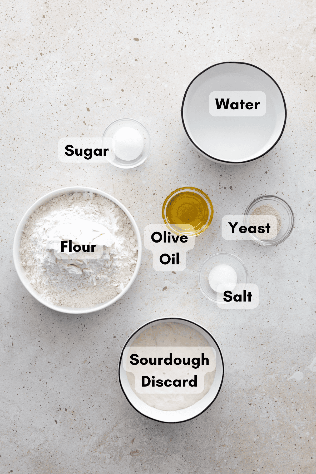 Ingredients for Sourdough Discard Pizza Dough in small bowls.
