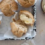 A closeup of a halved Banana Sourdough Muffin with butter on one side.