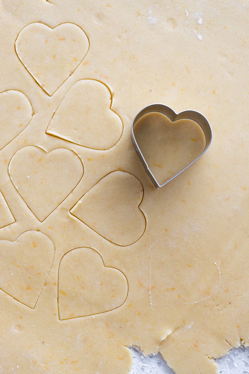 A heart cookie cutter on rolled dough.