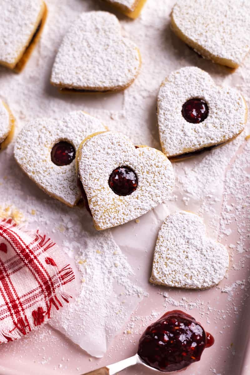 Heart Cookies with Jam stacked on a pink tray.