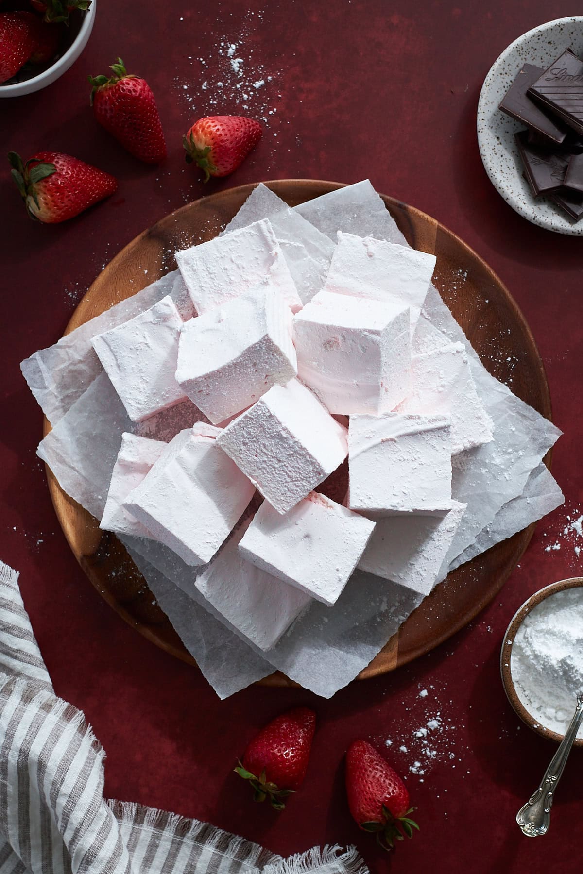 Strawberry Pink Marshmallows on a wooden platter. 