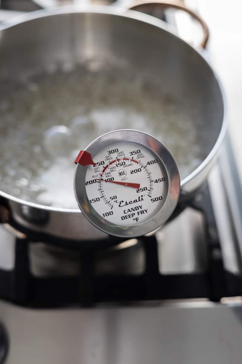 A candy thermometer showing temperature of the sugar.