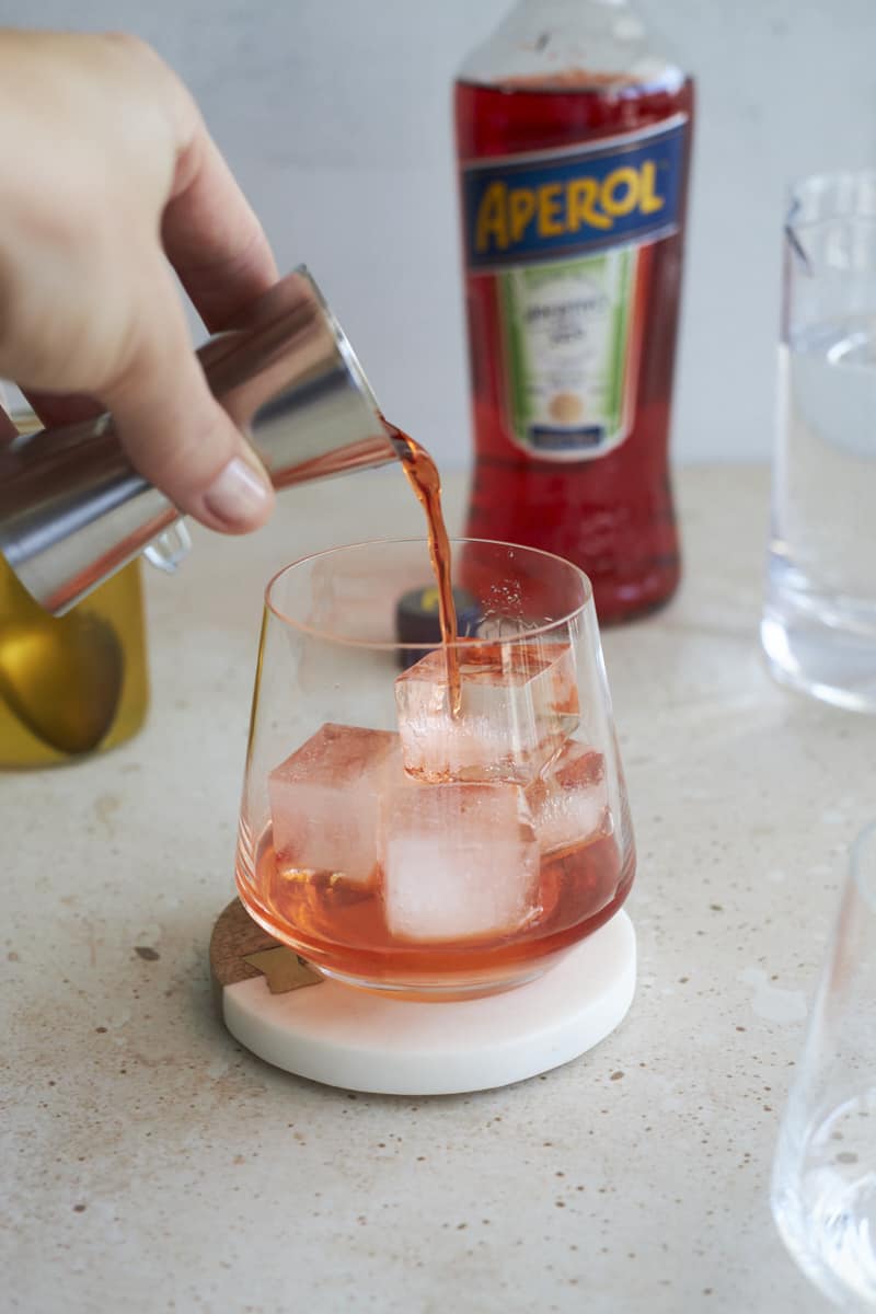 Aperol being poured into the cocktail glass.