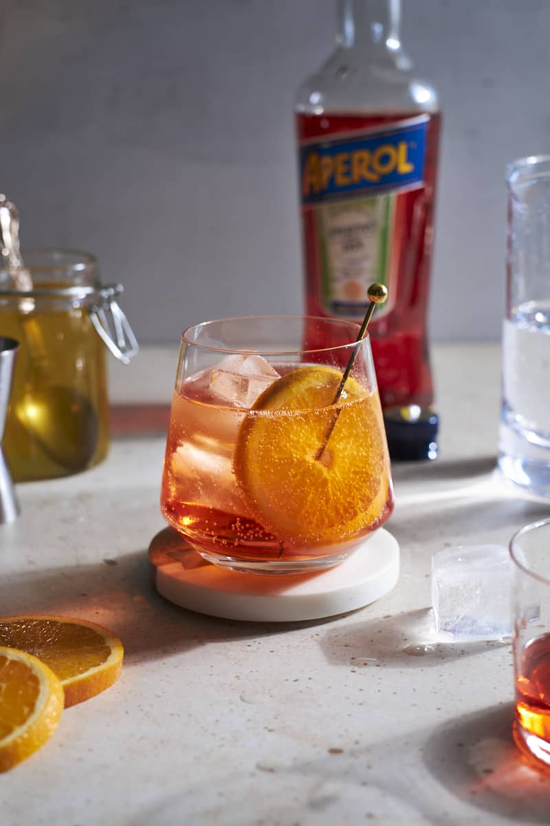 Aperol Soda in a cocktail glass garnished with an orange slice.