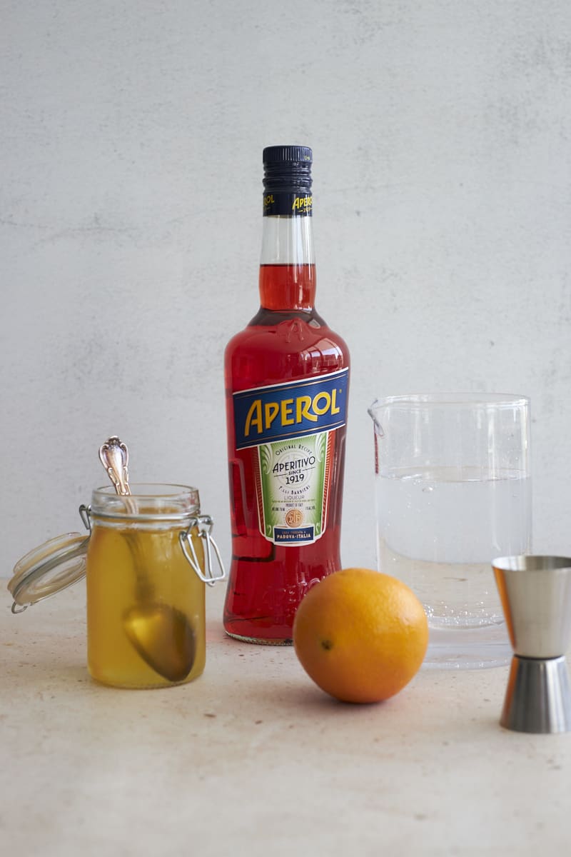 Ingredients for an Aperol Soda cocktail.