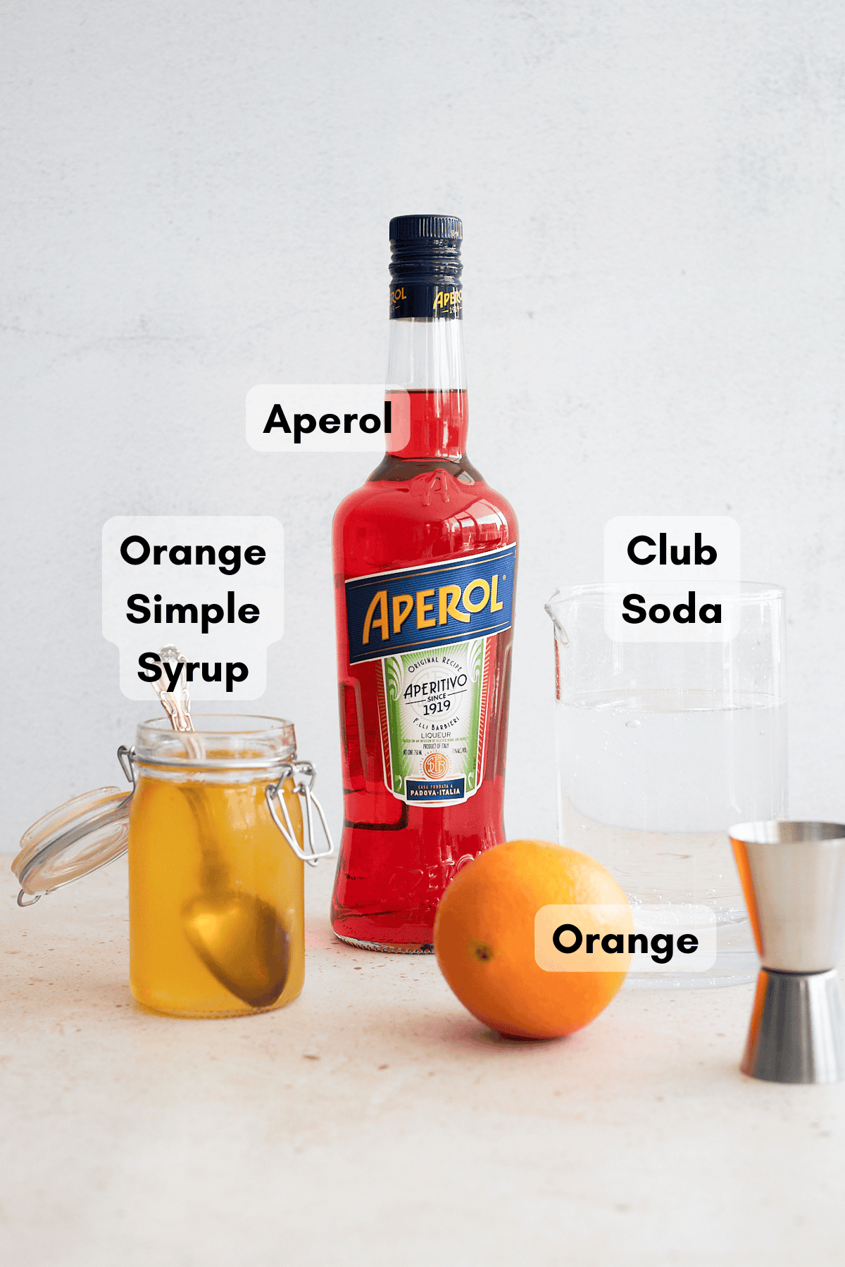 Ingredients for an Aperol Soda cocktail.