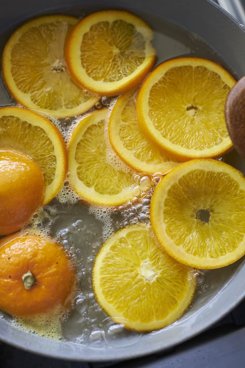 Orange slices boiling in the sugar water mixture.