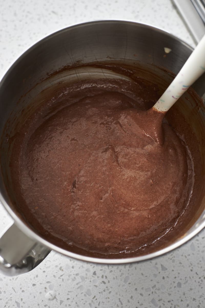 Brownie batter mixed together in a large metal bowl.