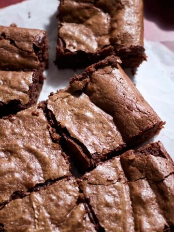 Sourdough Discard Brownies on white parchment paper.