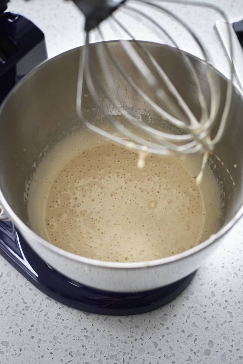 Eggs and sugar whipped in the bowl of a stand mixer.