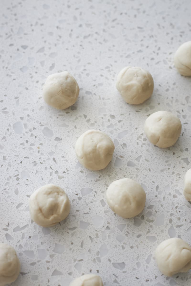 Dough shaped into small balls for pretzel bites.