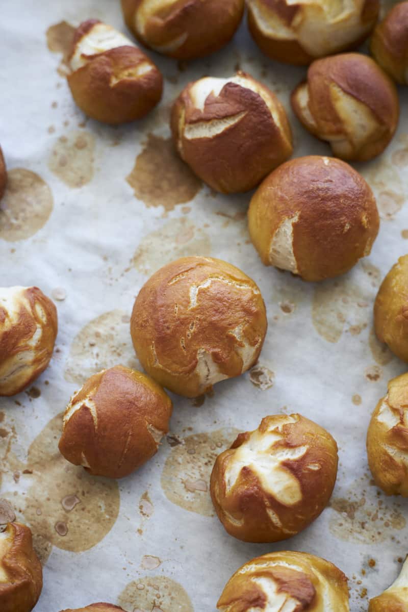 Baked pretzel bites on white parchment paper. 