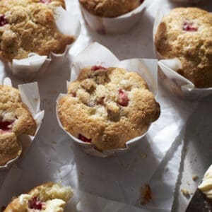 Strawberry Almond Muffins on white parchment paper.