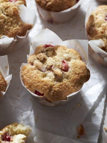 Strawberry Almond Muffins on white parchment paper.