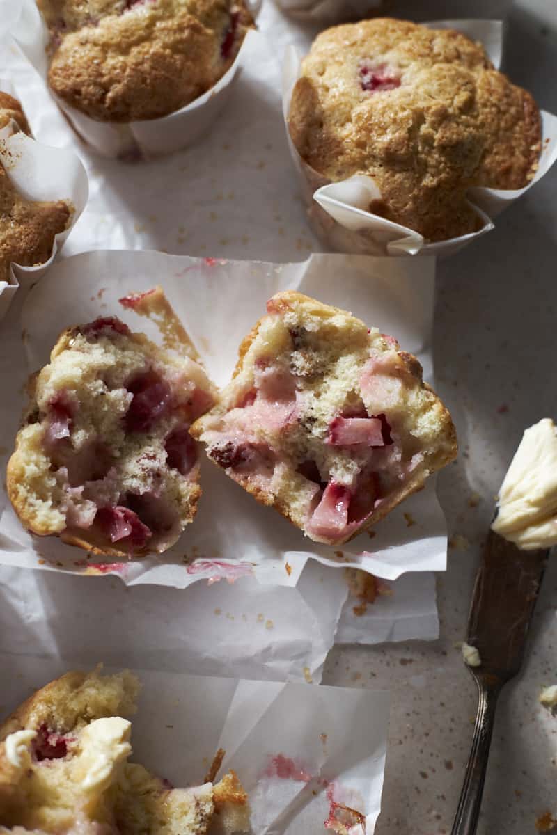 A halved muffin showing the strawberry chunks inside.