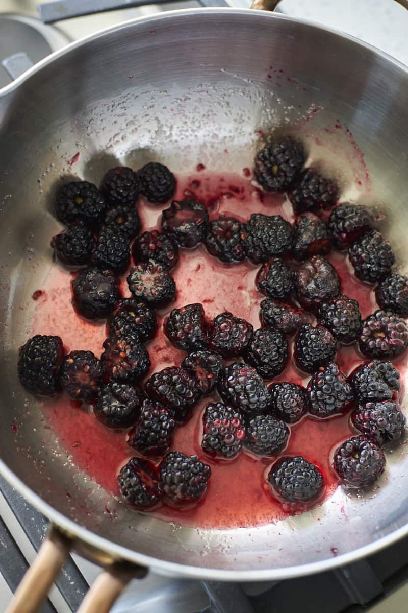 Blackberries added to a saucepan.