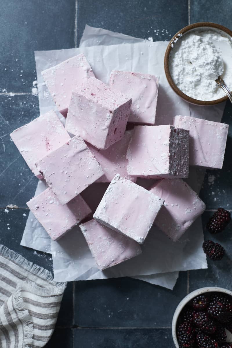 A pile of Blackberry Marshmallows on white parchment paper.