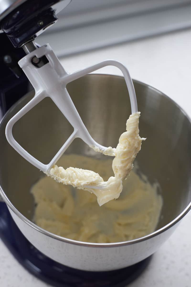 Creamed butter on the paddle of a stand mixer.
