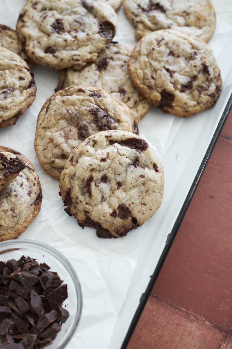 Chocolate chip sourdough discard cookies on a white tray.