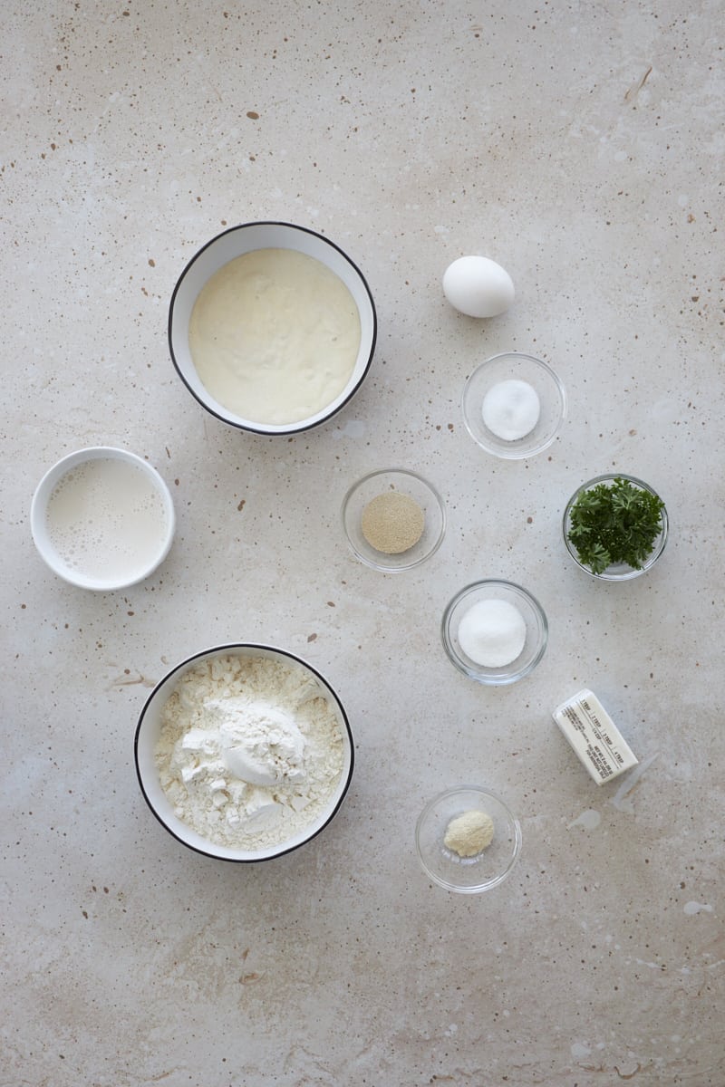 Ingredients for Sourdough Discard Garlic Rolls in small bowls.