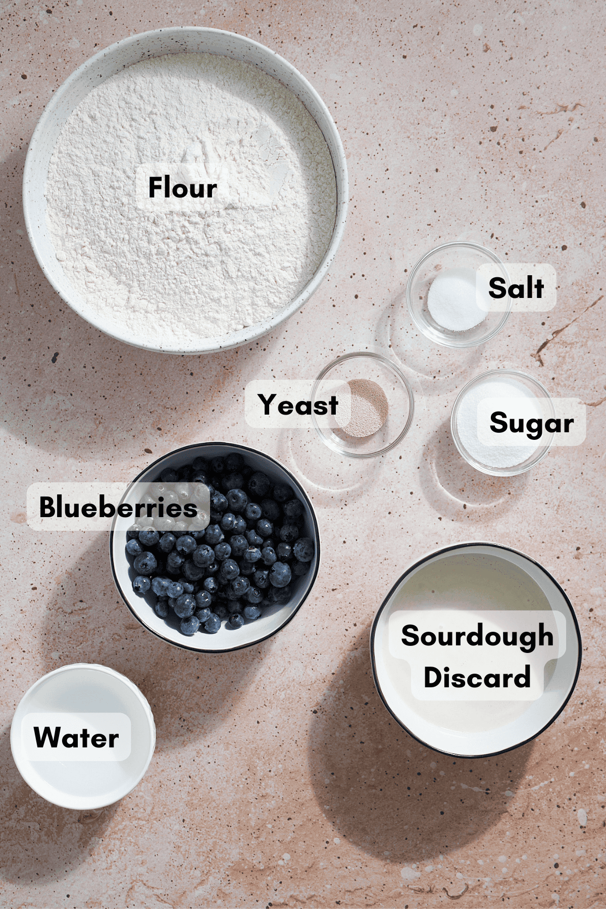Ingredients for Sourdough Discard Blueberry Bagels in small bowls. 