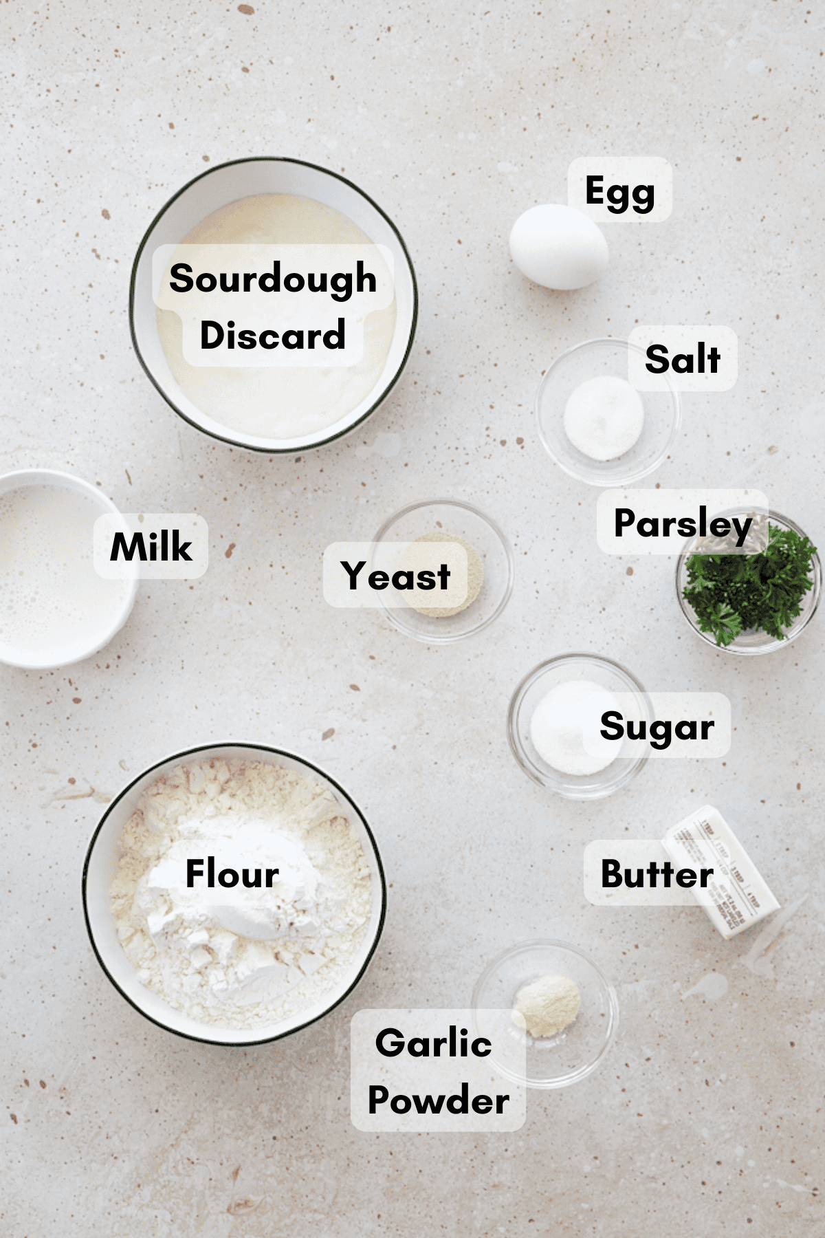 Ingredients for Sourdough Discard Garlic Rolls in small bowls. 