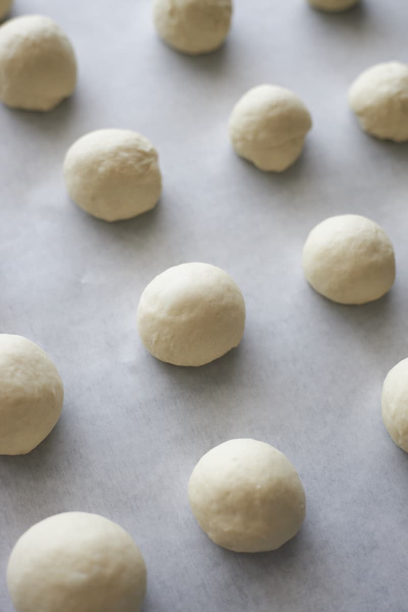 Shaped bagel bites on parchment paper.