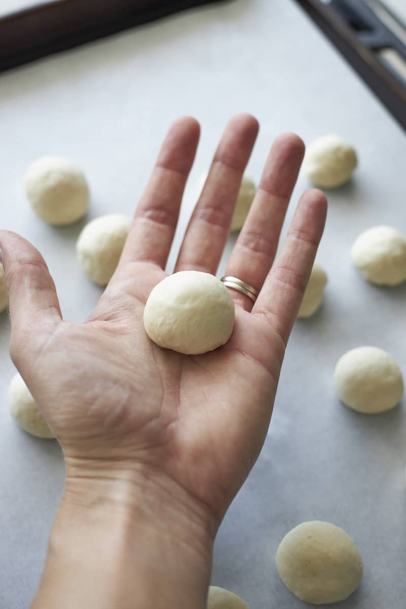 A bagel bite in the palm of a hand.