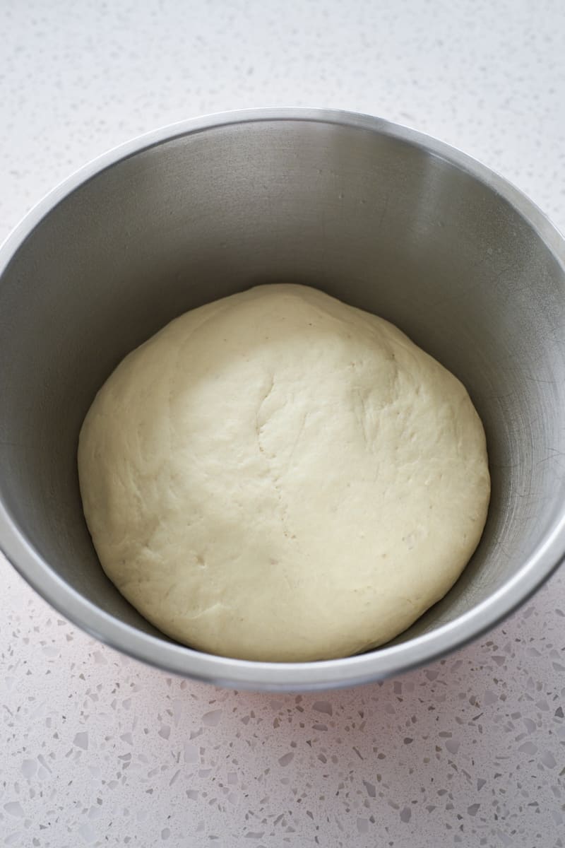 Dough after rising in a large bowl.