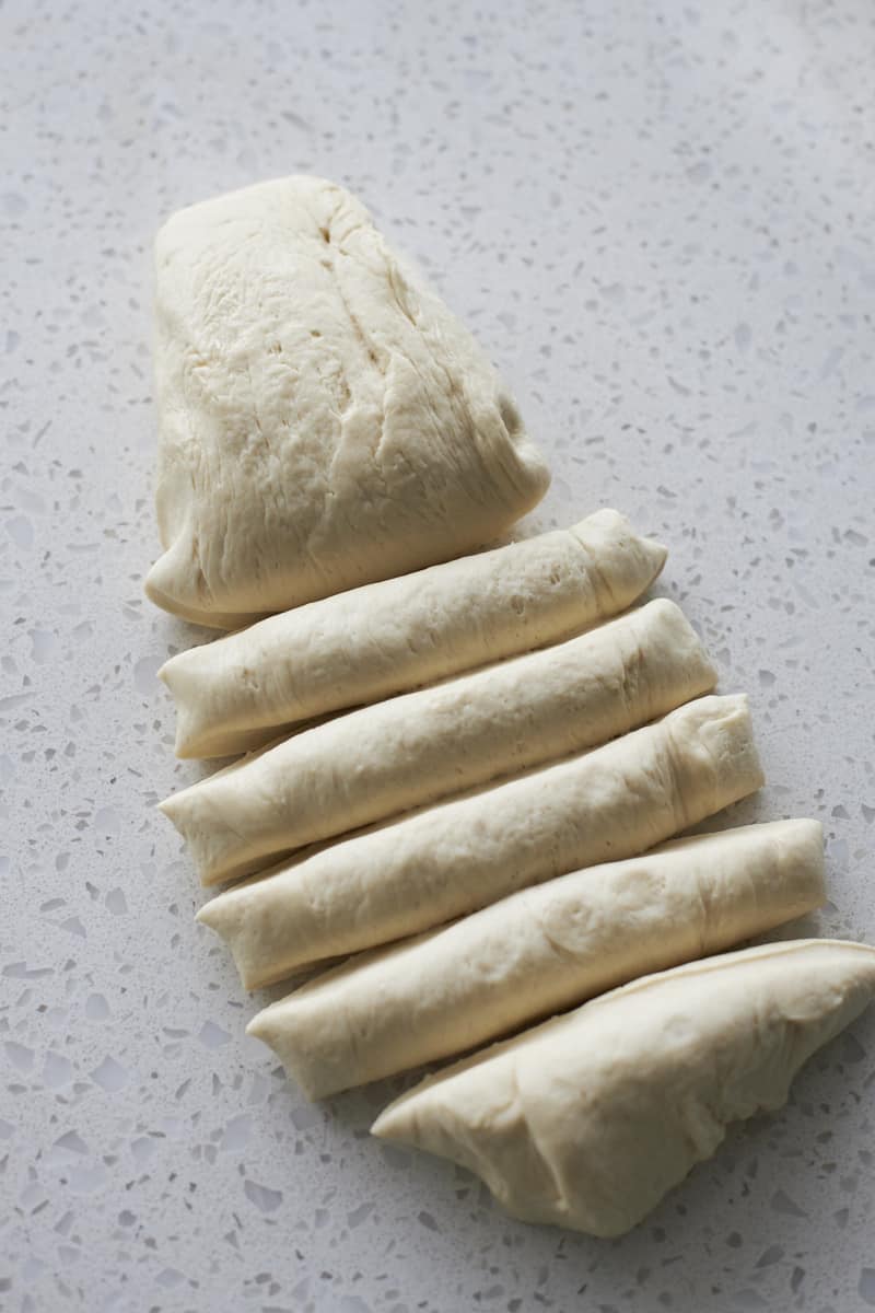 Dividing dough into pieces for breadsticks.