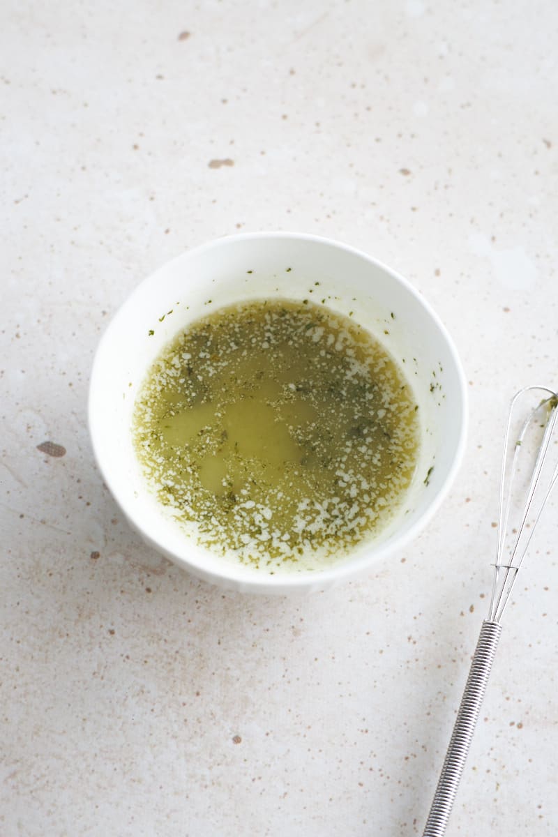 Garlic, butter and herb mixture in a small bowl.