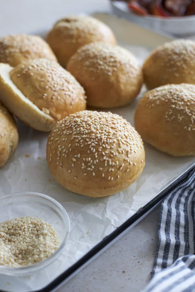 Sourdoug discard hamburger buns on a white tray.