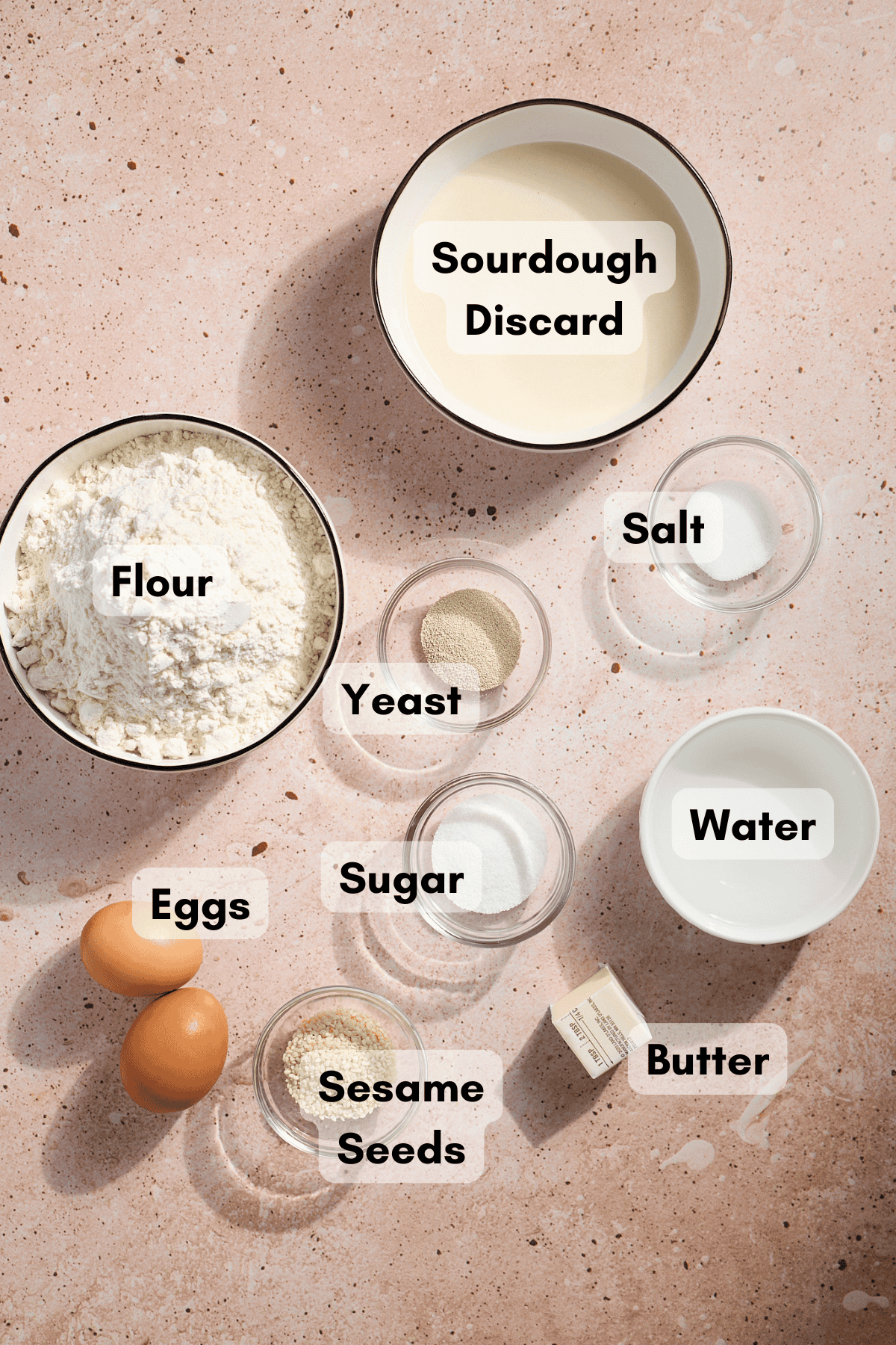 Ingredients for Sourdough Discard Hamburger Buns in small bowls.