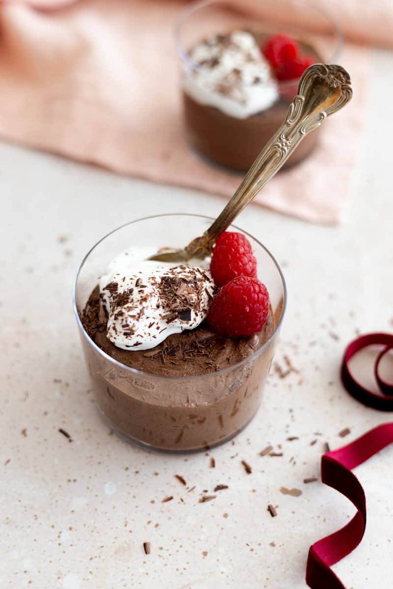 Dairy-Free Chocolate Mousse in a glass cup with a spoon.